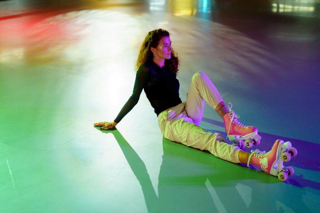 woman in black long sleeve shirt and pink pants lying on floor