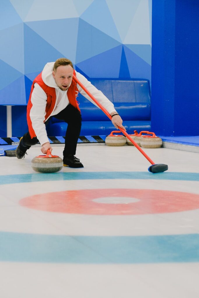 sportsman playing curling on ice