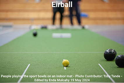 People playing the sport bowls on an indoor mat